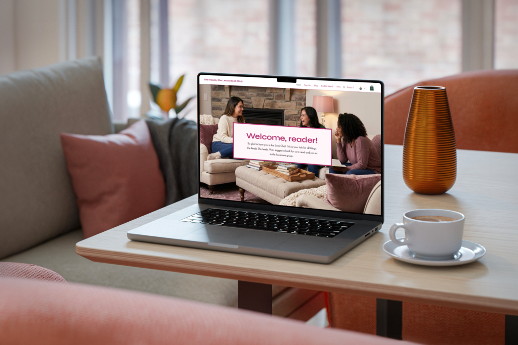 She Reads She Leads Book Club website on laptop sitting on a desk