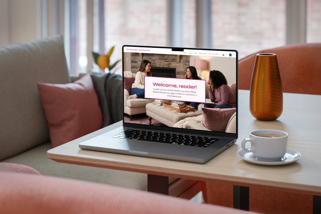 She Reads She Leads Book Club website on laptop sitting on a desk